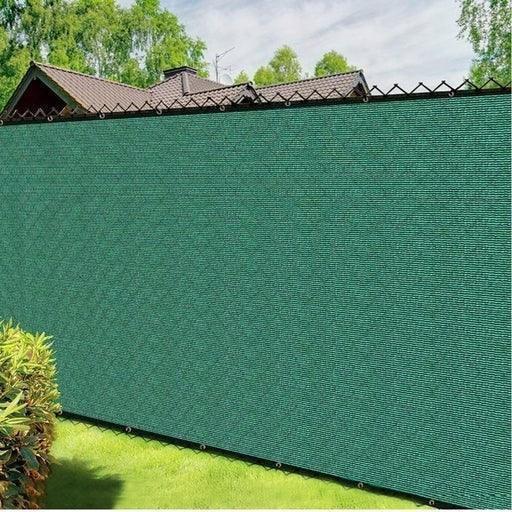 Green 4' x 50' 90% privacy fence mesh tarp attached to outdoor fencing