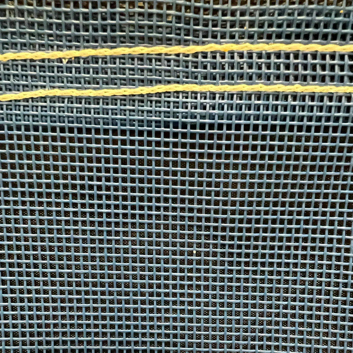 Blue 6' x 8' vinyl mesh tarp displaying breathable weave construction and edge support